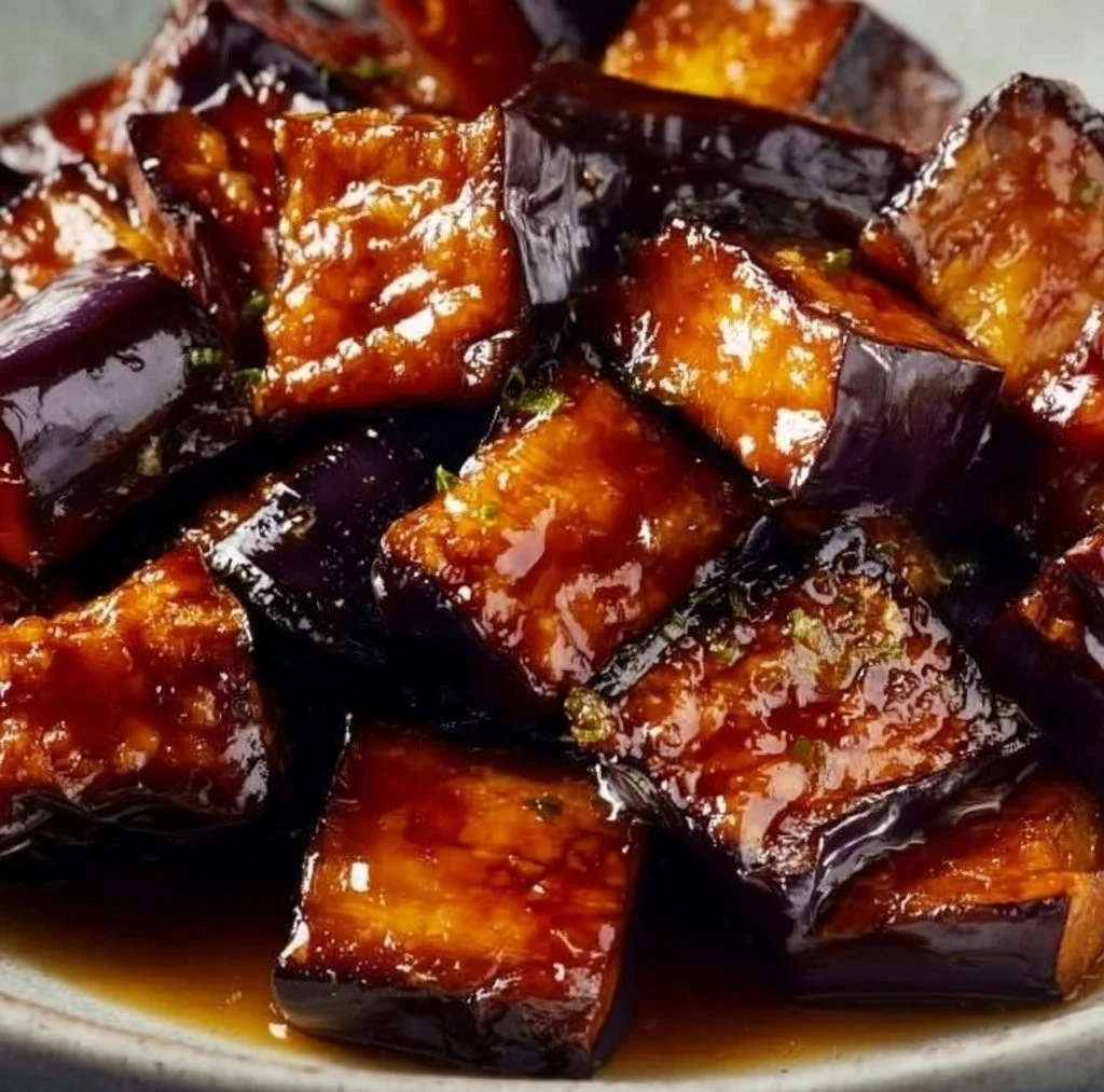 Delicious miso glazed eggplant served on a plate with garnishes.