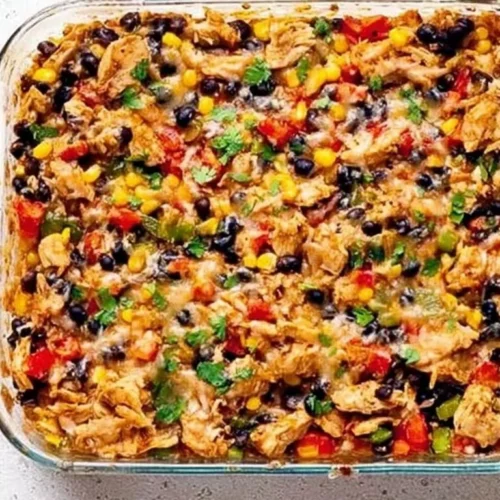Delicious protein burrito casserole topped with melted cheese and fresh ingredients