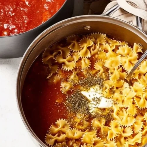 Bowl of delicious vegetarian lasagna soup topped with cheese and fresh herbs.