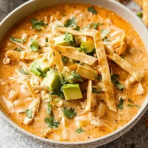 Bowl of creamy White Chicken Chili topped with cilantro and lime slices.