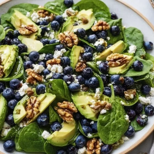 Delicious spinach blueberry salad with vibrant fresh ingredients.