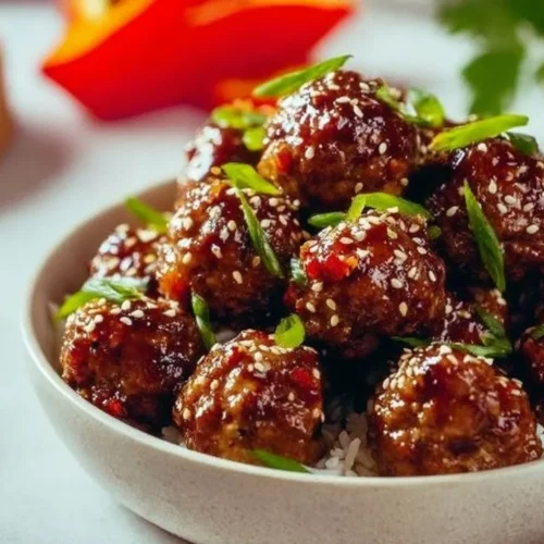 Delicious Asian meatballs served with dipping sauce on a platter.