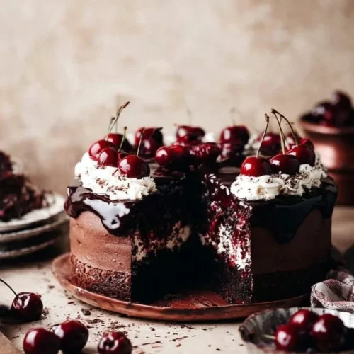 Decadent Black Forest Cheesecake with chocolate layers and cherry topping