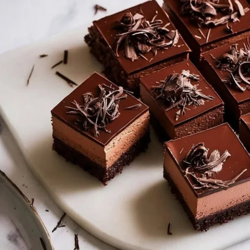 Delicious Chocolate Mousse Brownies topped with chocolate drizzle.