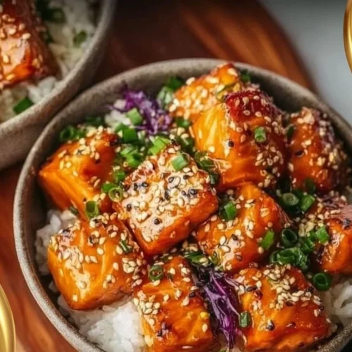 Crispy salmon rice bowl garnished with vegetables and sauce