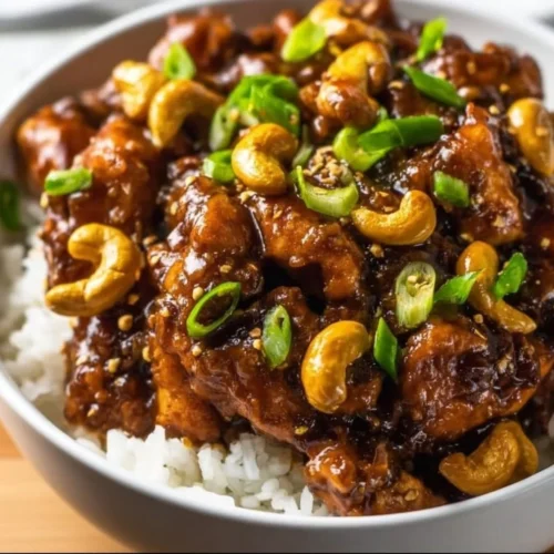 Delicious Crockpot Cashew Chicken served with vegetables and cashews