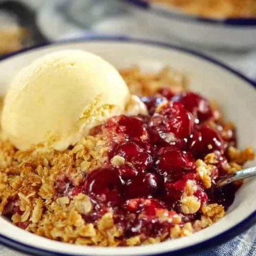 Delicious cherry crisp dessert with a golden crumble topping served in a bowl