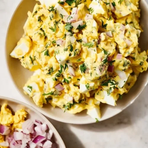 Bowl of easy egg salad with chopped eggs and garnishes