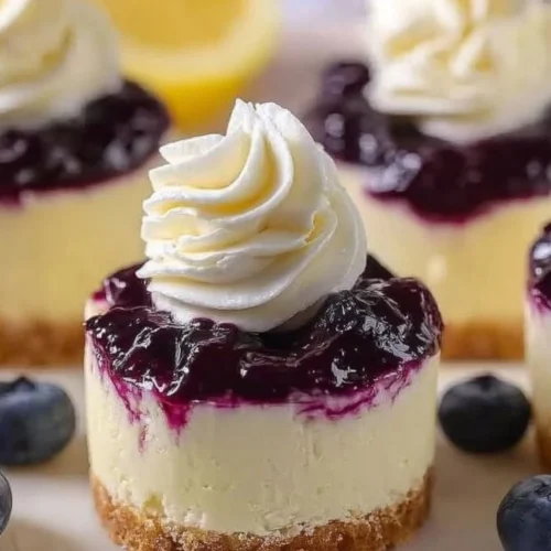 Healthy mini lemon blueberry cheesecakes with fresh blueberries and lemon zest.