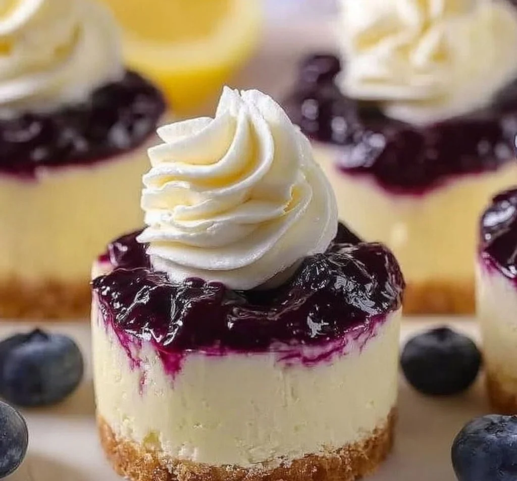 Healthy mini lemon blueberry cheesecakes with fresh blueberries and lemon zest.