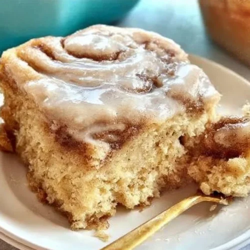Homemade cinnamon roll cake with icing and cinnamon swirl topping
