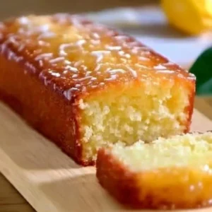 Moist Keto Lemon Yogurt Cake topped with lemon zest and fresh berries