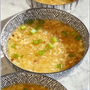 Bowl of low carb egg drop soup garnished with green onions