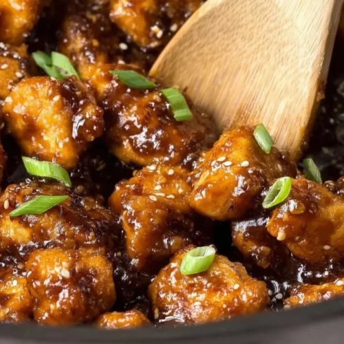 Plate of Slow Cooker General Tso's Chicken garnished with green onions