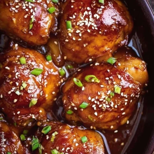 Slow Cooker Mongolian Chicken served in a bowl with rice and vegetables