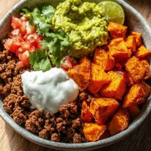 Colorful Sweet Potato Taco Bowl topped with fresh ingredients and spices.