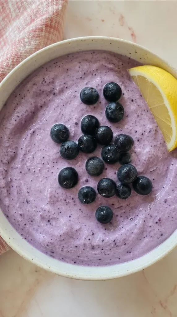 Bowl of easy cottage cheese ice cream topped with fresh fruit