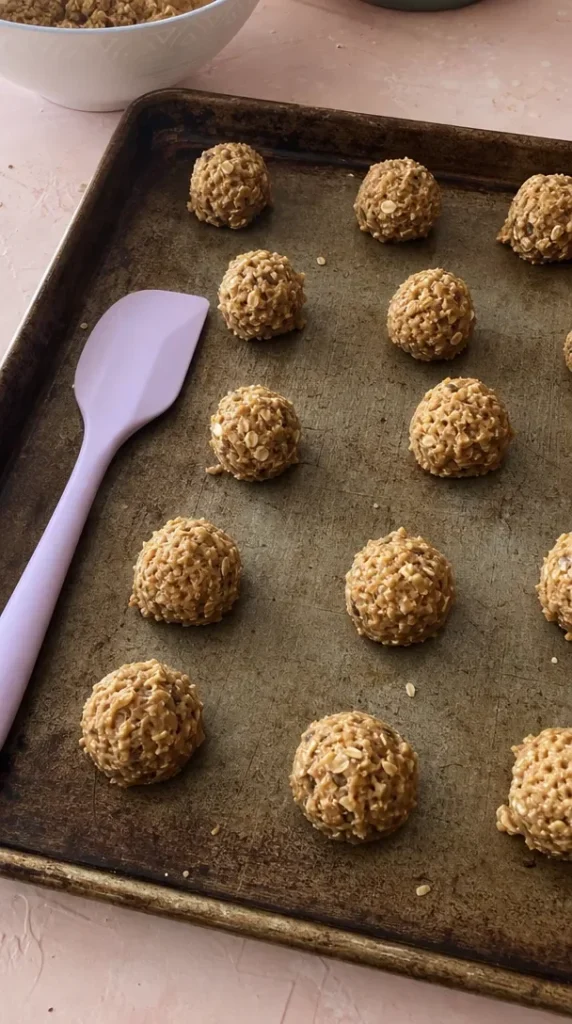 Freshly baked peanut butter oatmeal cookies on a wooden table