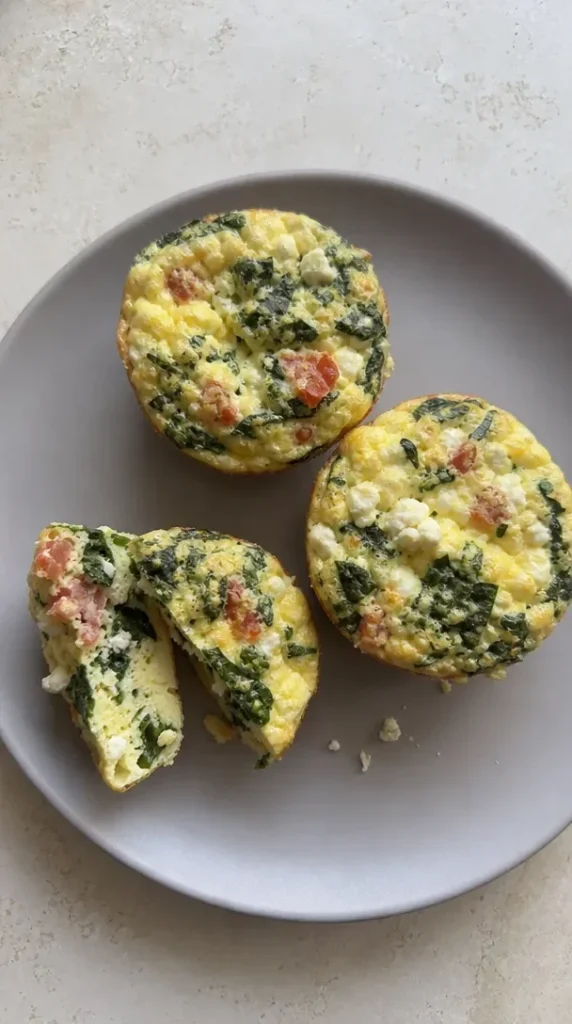 Mediterranean spinach and feta egg bites served in a colorful dish
