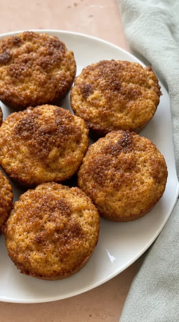Delicious low-carb apple spice muffins on a wooden table.